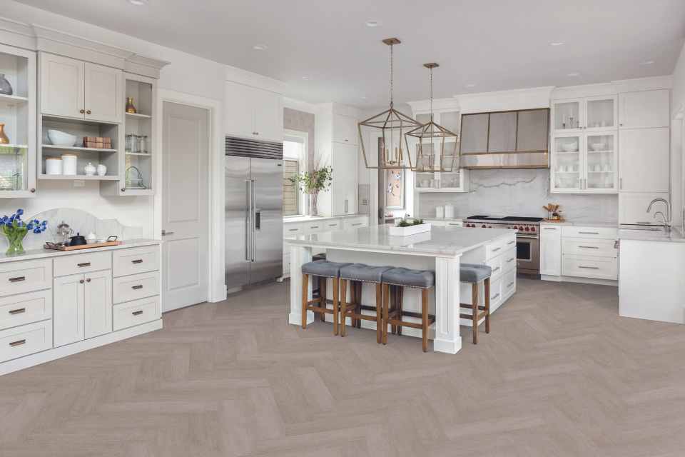 gray washed luxury vinyl herringbone in white modern kitchen